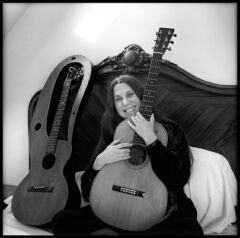Flip with guitar in antique bed
